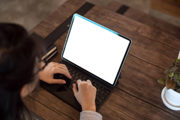 istock Close up. Hand businesswoman using digital tablet on white screen on table. Mock up. 1309095147