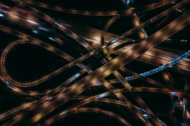 istock Aerial View of Complex Overpass and Busy Traffic at Night 1309098980