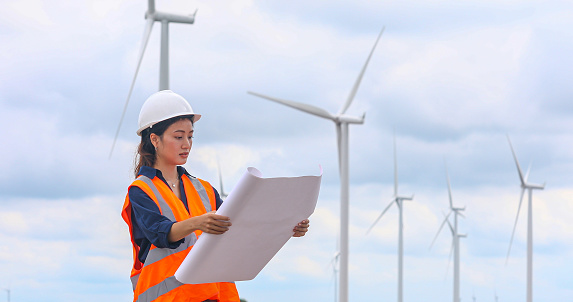 Women engineer working on-site at wind turbine farm