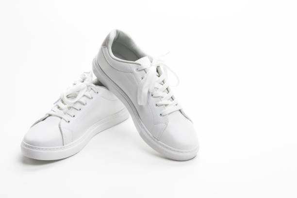 istock Pair of New White Sneakers Over White Background. Horizontal Composition 1309099449