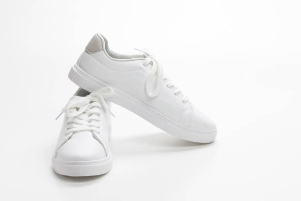 istock Pair of White Sneakers with Cellphone and Wallet Over White Background. Horizontal Image 1309099459