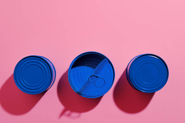 istock Aesthetic concept with blue painted tin can on pink background 1309100170