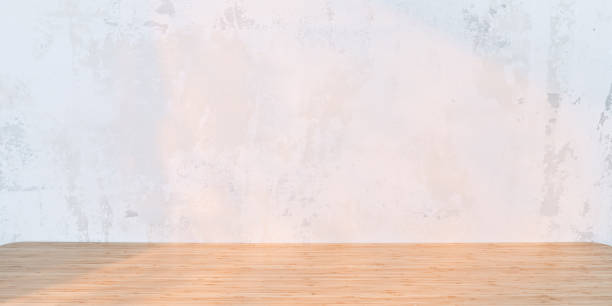 istock Light background with wooden table and shabby wall in sunrise or sunset light 1309100508
