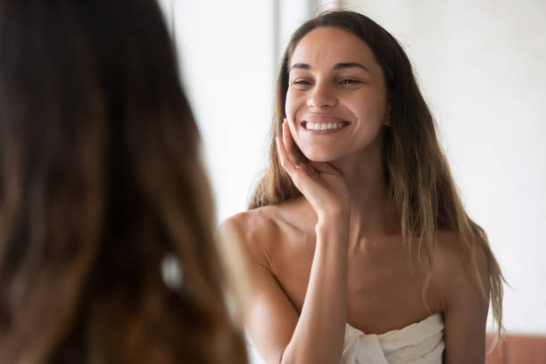 istock Charming young lady enjoying her reflection in bathroom mirror 1309101113