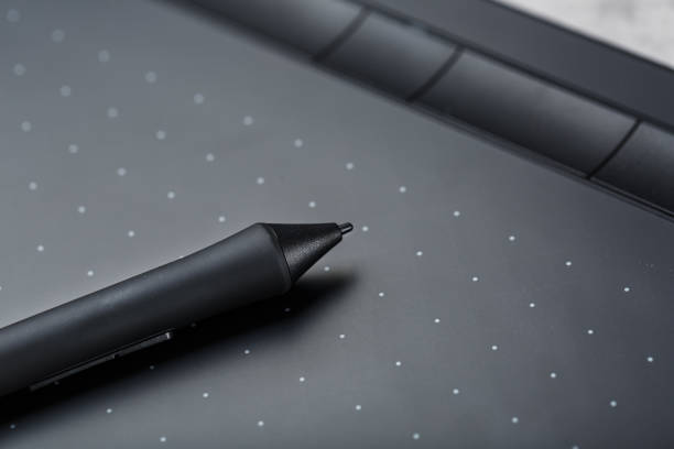 istock Graphic tablet with a pen working designer, close-up. Gadget for creativity and work of a photographer, Illustrator and art artist. 1309101805