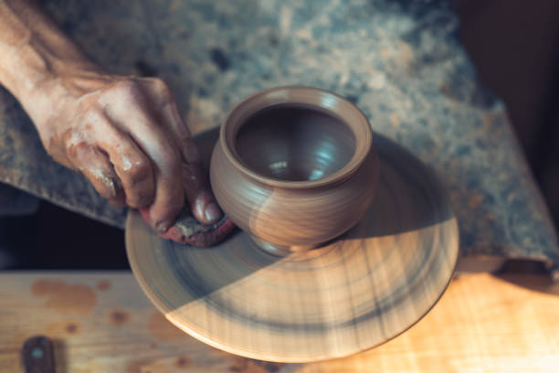 istock In the ceramics workshop. Unfired clay pot on a potter's wheel. Place for your text. 1309103413
