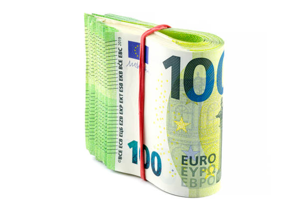 macro shot of the european union 100 euro banknote, stack of banknotes folded in half wrapped with a rubber band, isolated on a white background. - european union euro note european union currency paper currency currency imagens e fotografias de stock
