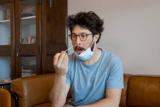 istock Man self test for COVID-19 home test kit. 1309104819