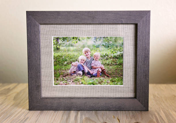 Rustic Wood Framed Portrait of a Family of Three Children Outside stock photo