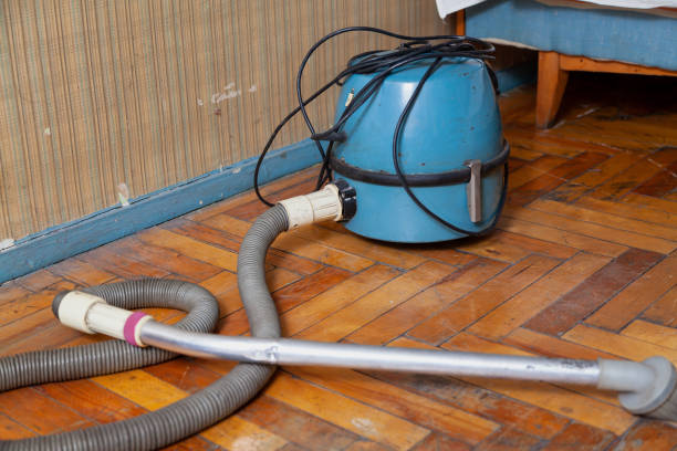 istock Blue vacuum cleaner stands on old parquet floor 1309106640