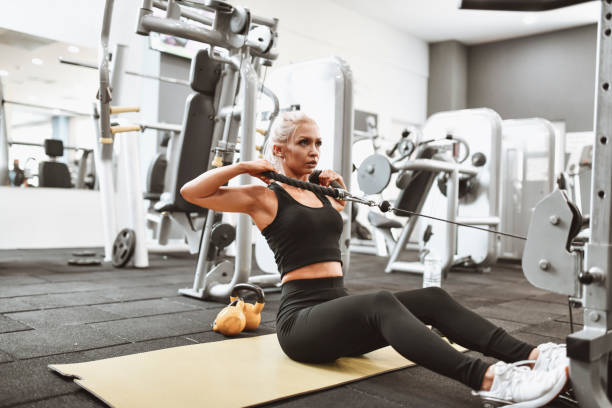 istock Seated Rowing Exercise By Modern Female Athlete In Gym 1309106791