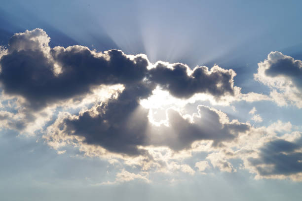 istock The sun's rays peek out from behind the gray clouds in the sky 1309107590