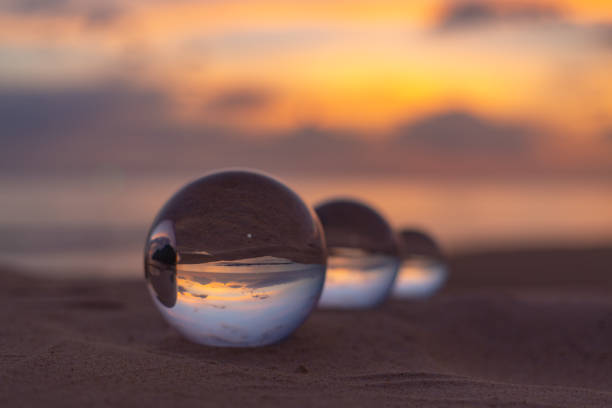 istock Three crystal balls in beautiful sunset on the beach 1309108931