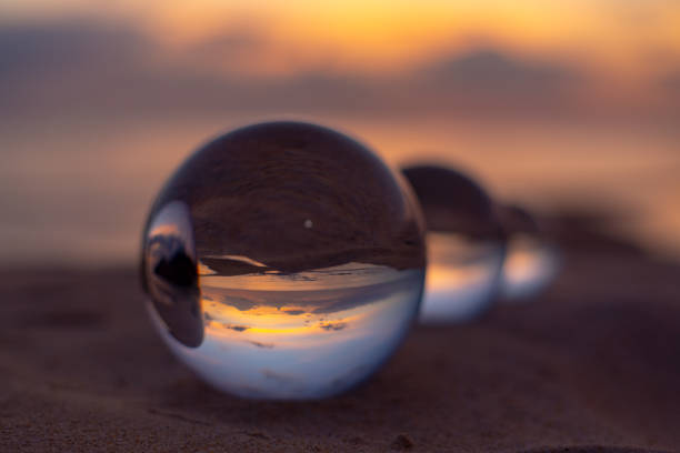 istock Three crystal balls in beautiful sunset on the beach 1309108946