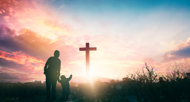 Parents and children worship on the cross background stock photo