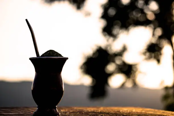 Photo of Chimarrão, a traditional Brazilian yerba mate tea. Typical South American drink with Serra Gaúcha in the background