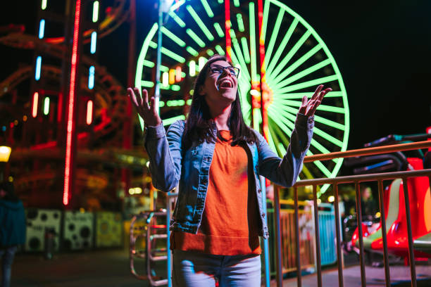 istock Cheerful woman in amusement park 1309111982