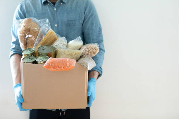 istock Mens holding donation box 1309112086