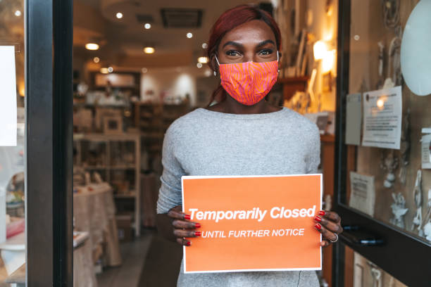 istock Woman holding a closed sign 1309115128