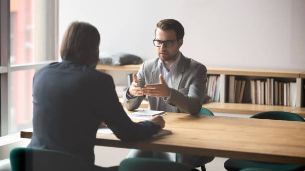 Two successful male partners negotiation project ideas in boardroom. Serious businessman discussing contract details or finding problem solution with skilled financial advisor in modern office. Two successful male partners negotiation project ideas in boardroom. interview stock pictures, royalty-free photos & images