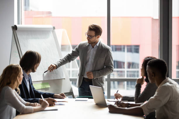 istock Skilled 30s caucasian leader in eyeglasses coaching employees. 1309116008