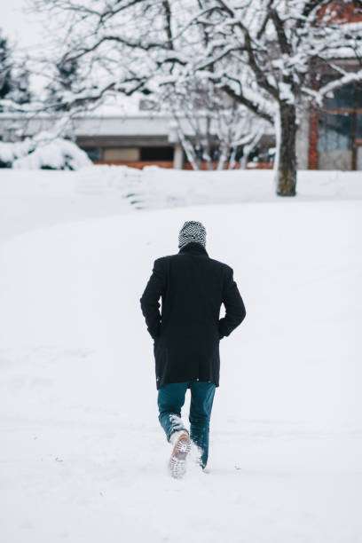 istock Man walking through the snow 1309116102