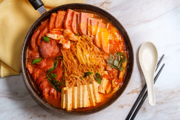 Korean Army Base Stew Korean comfort food army base stew also known as Budae-jjigae with sausage tofu and canned ham side dish stock pictures, royalty-free photos & images
