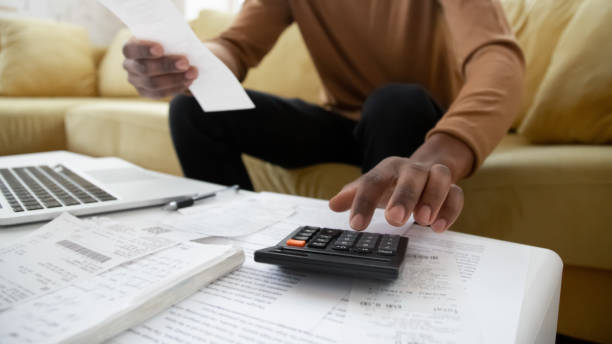 istock Black small business owner making calculations at home close up 1309117489
