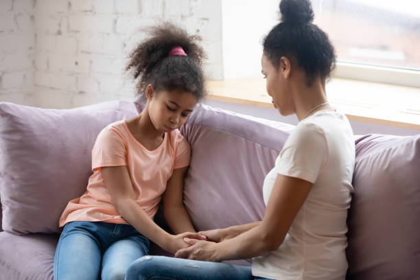 istock Attentive caring black mother supporting her school age daughter 1309117567