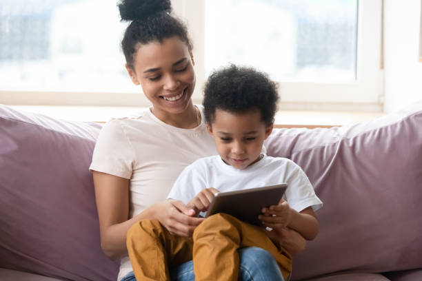 istock African mother teaching little son to read using tablet pc 1309117572