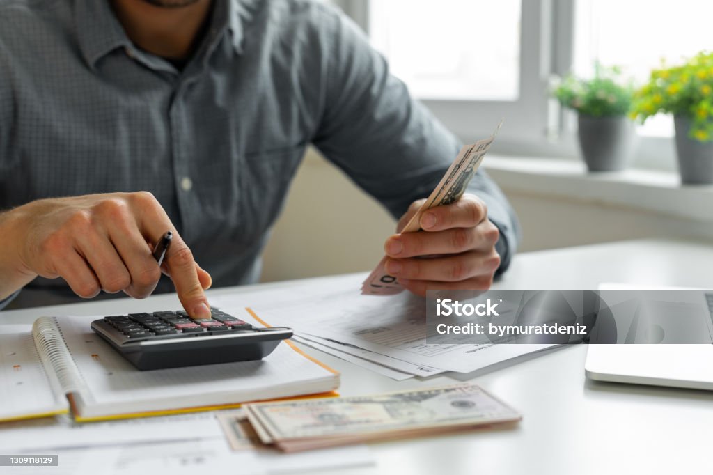 Man using calculator Financial Loan Stock Photo