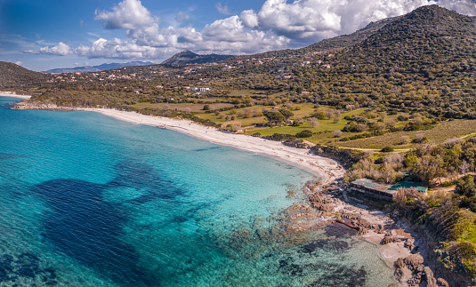 Aerial view on a bright sunny day of the turquoise Mediterranean sea at Ghjunchitu beach in the Balagne region of Corsica