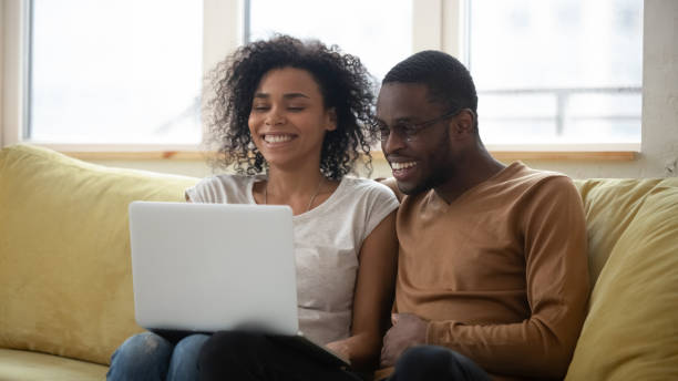 istock Happy african american family having good time using laptop. 1309119334