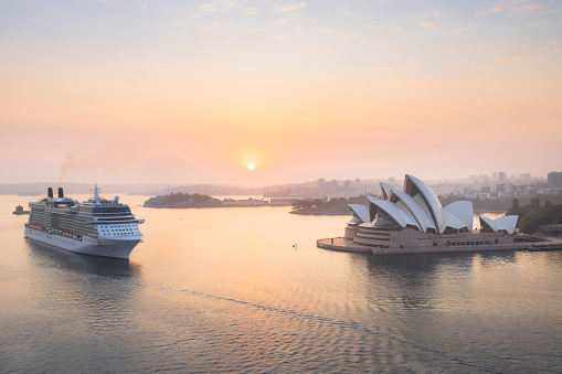 Celebrity Cruises cruise ship Solstice approaches Sydney Opera House and Sydney Harbour on a summer morning at sunrise.