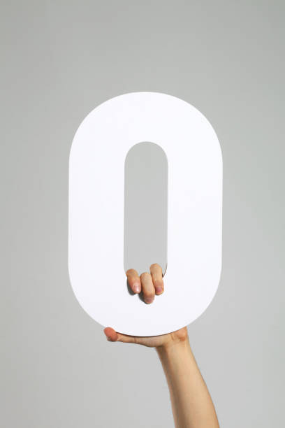 Letter O Or Zero A hand holding the letter O or zero. zero photos stock pictures, royalty-free photos & images