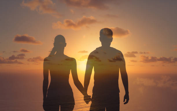 istock Couple holding hands at sunset. 1309122171