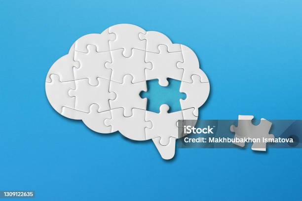 Brain Shaped White Jigsaw Puzzle On Blue Background A Missing Piece Of The Brain Puzzle Mental Health And Problems With Memory Stock Photo - Download Image Now