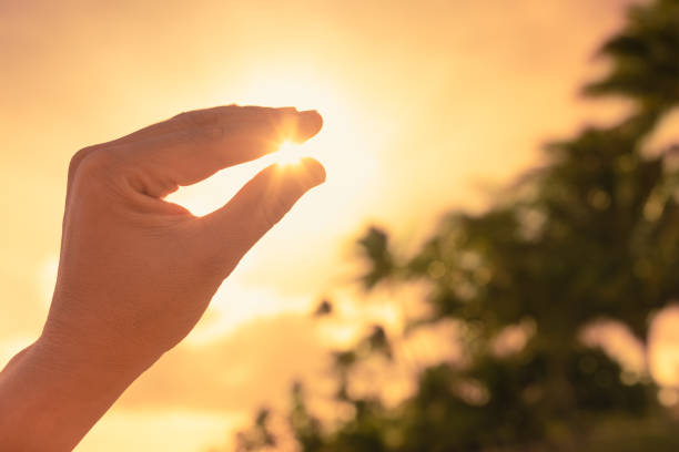 Holding the sun in fingers.
