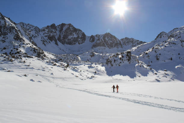 istock Two skiers going deep into the mountains on a beautiful day 1309122675