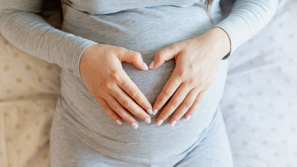 istock Pregnant woman lying on the bed 1309123825