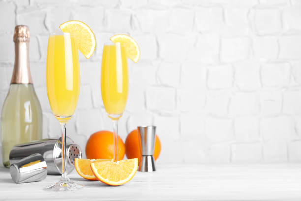 fresh alcoholic mimosa cocktails and fresh orange fruits on white wooden table, space for text - orange wall imagens e fotografias de stock