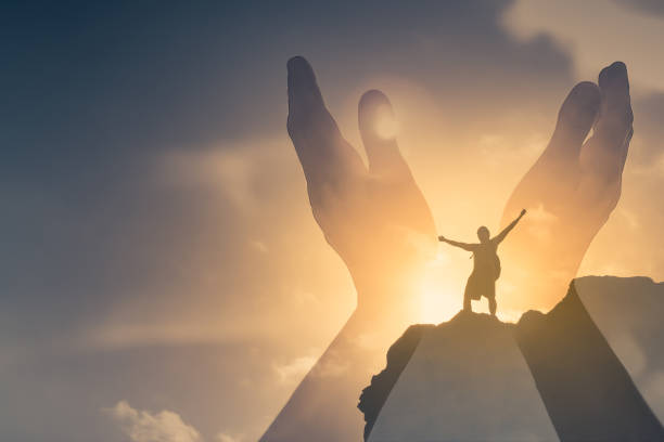 istock Worshiping hands up to the sun light sky. 1309123978