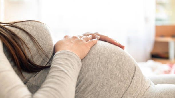 istock Pregnant woman lying on the bed 1309124020