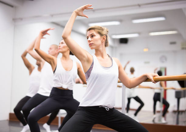 istock European  girl  training in  ballet class with other dancers 1309124143