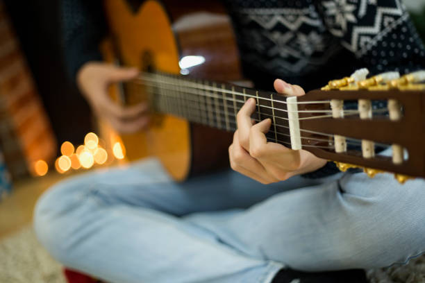istock Man playing on Guitar on Christmas 1309124271