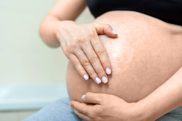 istock Pregnant woman holding belly 1309124840