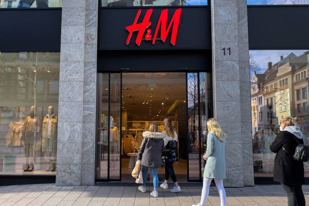 H and M store in Fulda, Germany People walking into an H and M store in Fulda, Germany h and m stock pictures, royalty-free photos & images