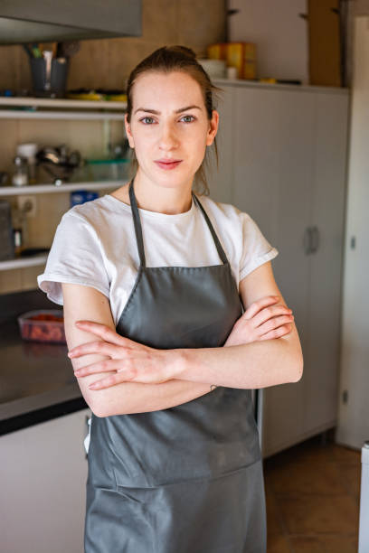 istock Portrait of a chef standing with her arms folded in the kitchen 1309126212