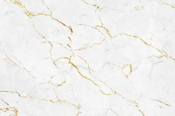 Closeup photo background of natural marble pattern. White marble stone texture with golden veins, front view