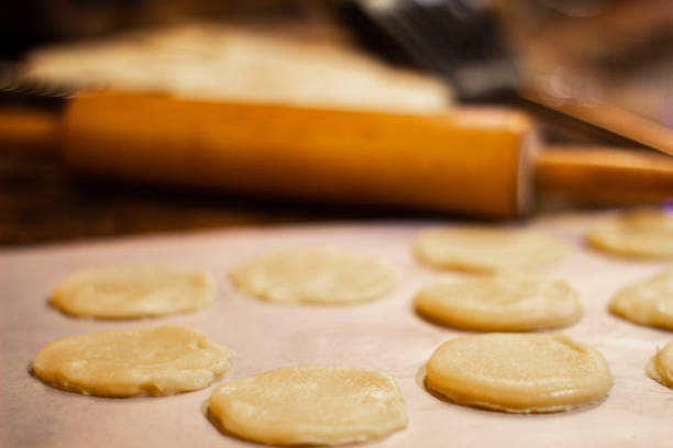 istock Sugar cookie dough, rolling pin, cookies, spatula and mixing bowl for baking cookies. 1309129116